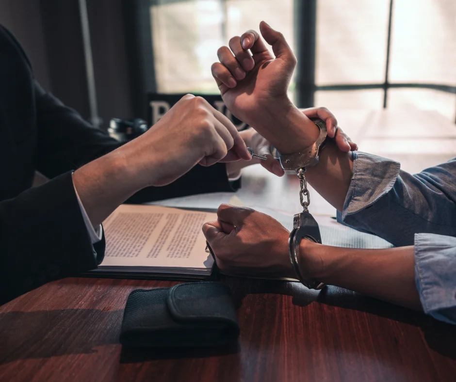 A parole officer opening the handcuffs of a criminal